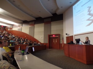 Erin presents to a group at Des Moines University.