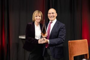 Erin receives an award from Above and Beyond in 2022.
