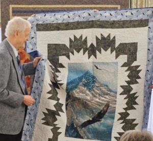 Randle admires the Quilt of Valor that was presented to him at the ceremony.