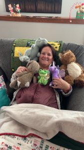 Julie with stuffed animals her grandkids gave her after surgery.